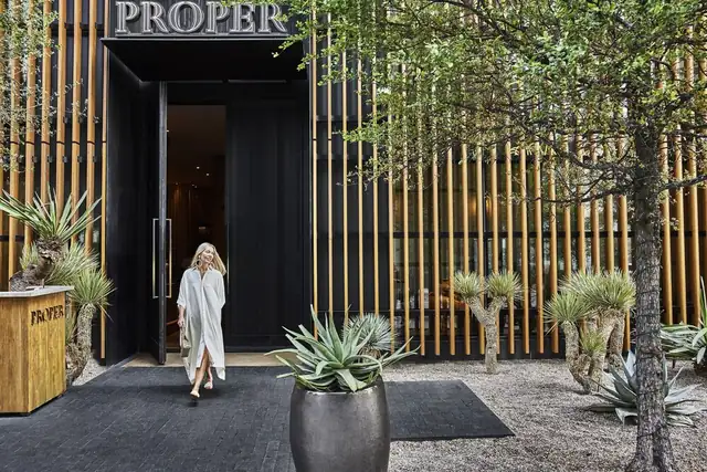Austin Proper Hotel in Austin, entrance with a black facade and a Proper sign