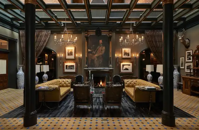 Hotel Jerome in Aspen, large room with a fireplace and two armchairs