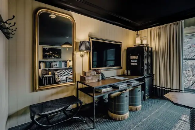 Hotel Jerome in Aspen, guest room with a large mirror and desk