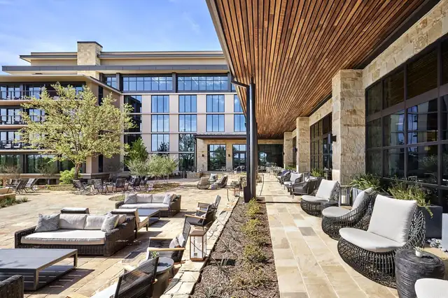 Omni PGA Frisco Resort in Frisco, patio with wicker furniture and stone