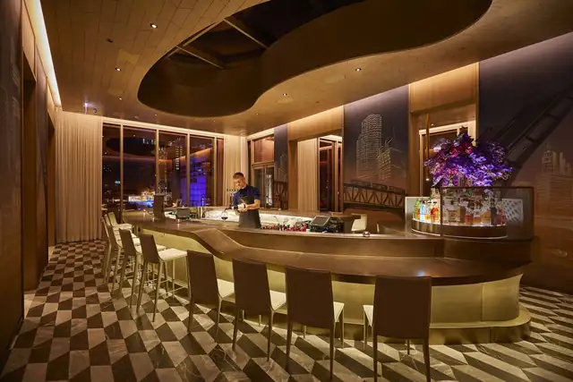 The Peninsula Chicago in Chicago, modern bar with a checkered floor and stools