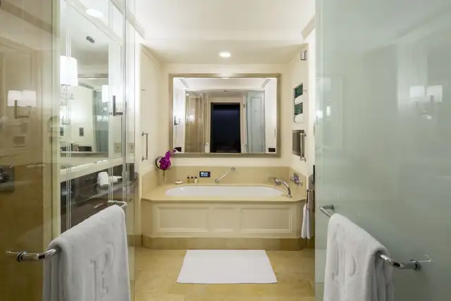 The Peninsula Chicago in Chicago, modern bathroom with a large tub and glass shower