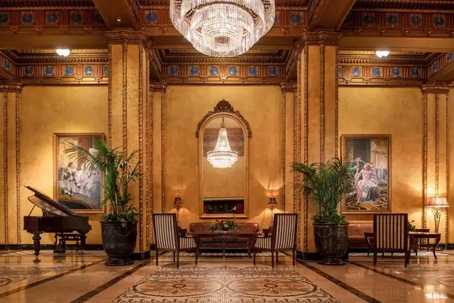The Roosevelt in New Orleans, lobby with a grand piano, chandeliers and large paintings