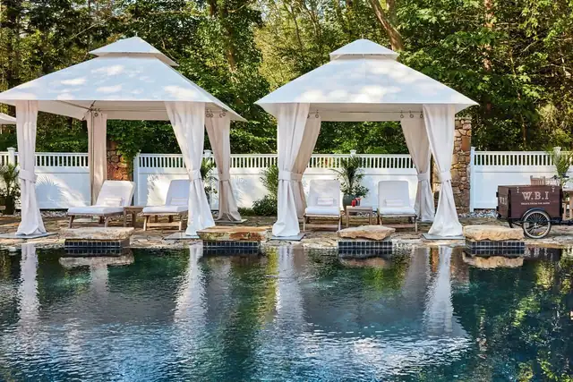 White Barn Inn in Kennebunkport, pool with two white gazebos and lounge chairs